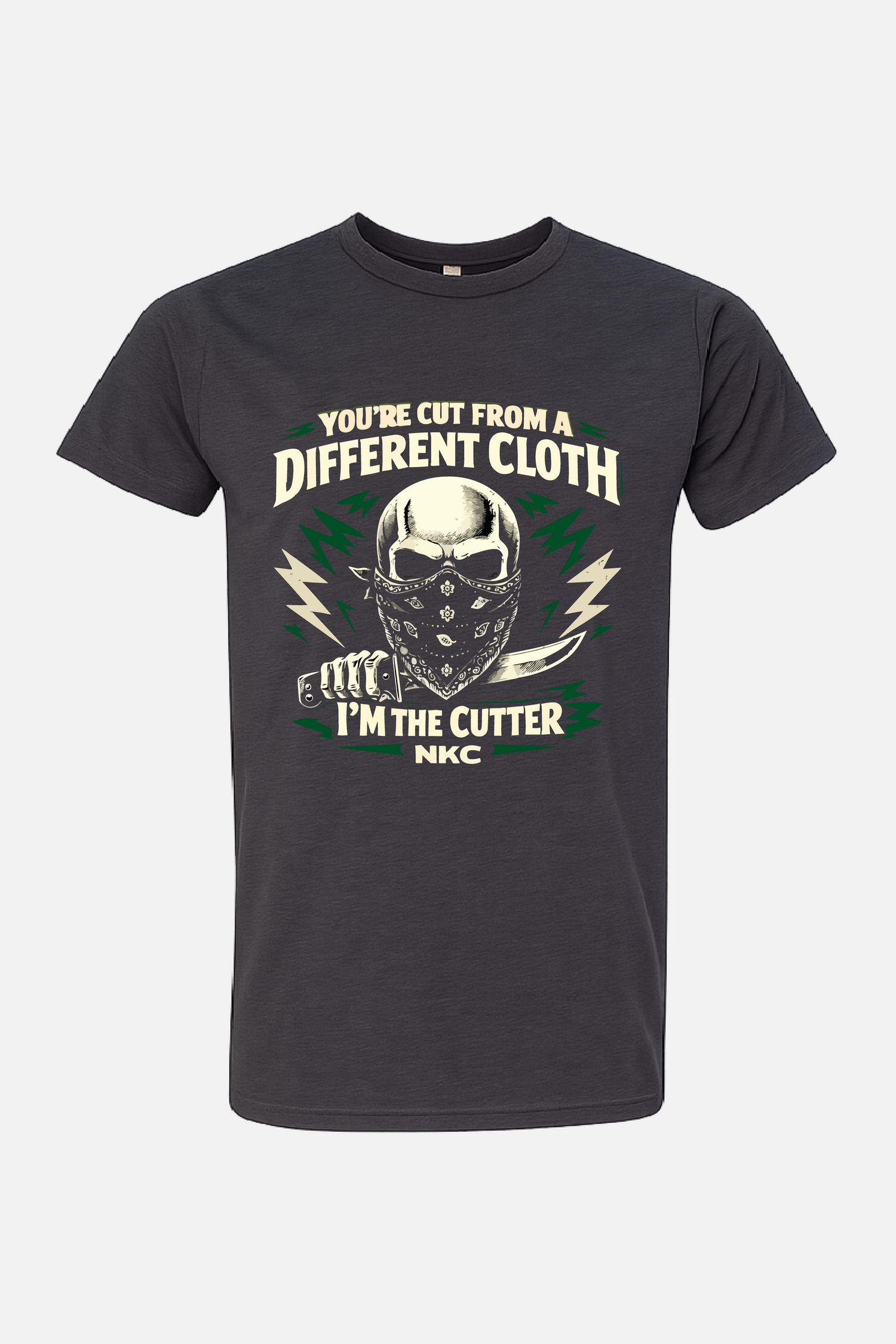 Gray t-shirt featuring a graphic of a masked skull holding a knife, surrounded by lightning accents, with the text “You’re Cut From a Different Cloth” above and “I’m the Cutter NKC” below.