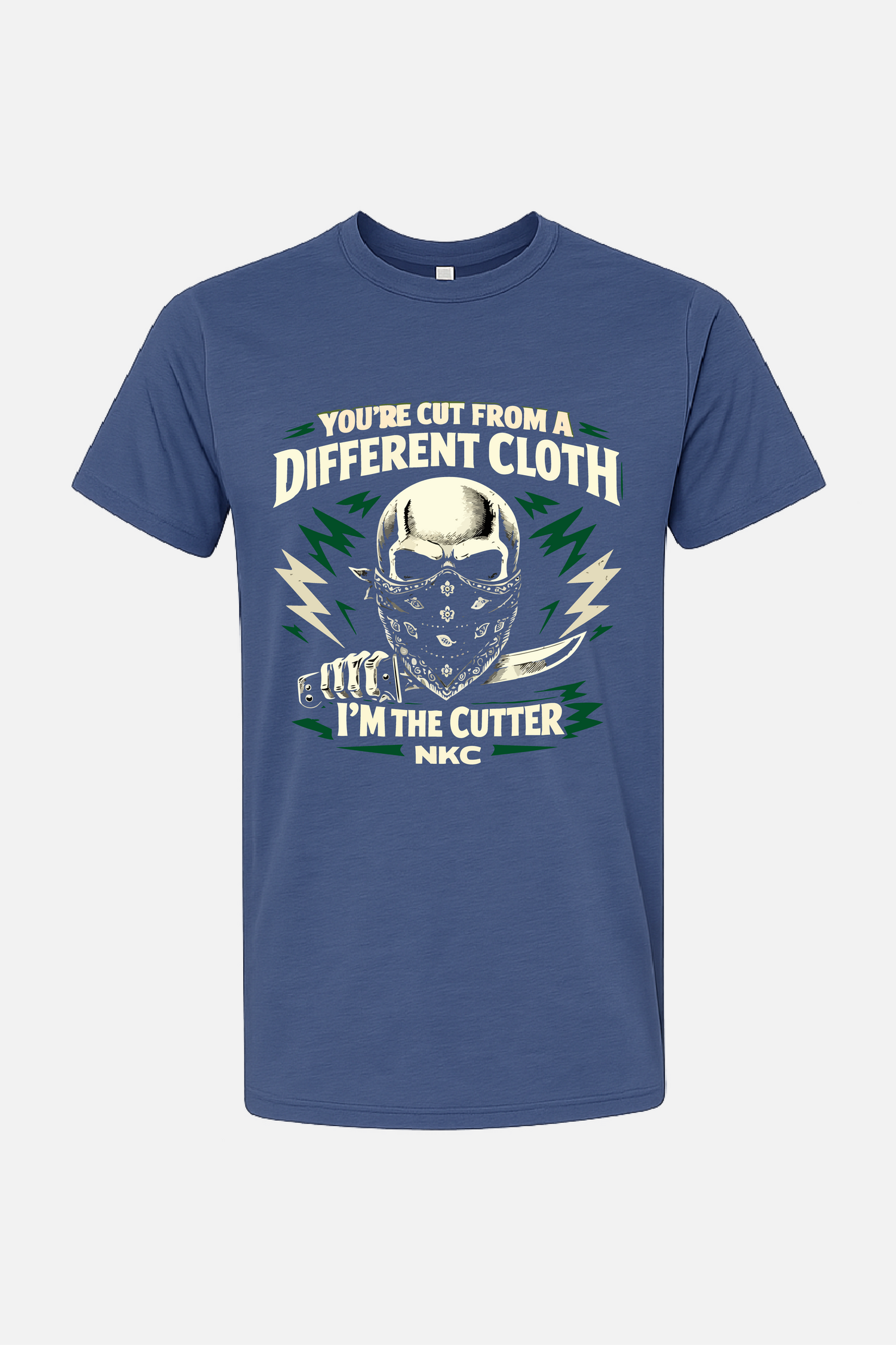 Blue t-shirt featuring a graphic of a masked skull holding a knife, surrounded by lightning accents, with the text “You’re Cut From a Different Cloth” above and “I’m the Cutter NKC” below.